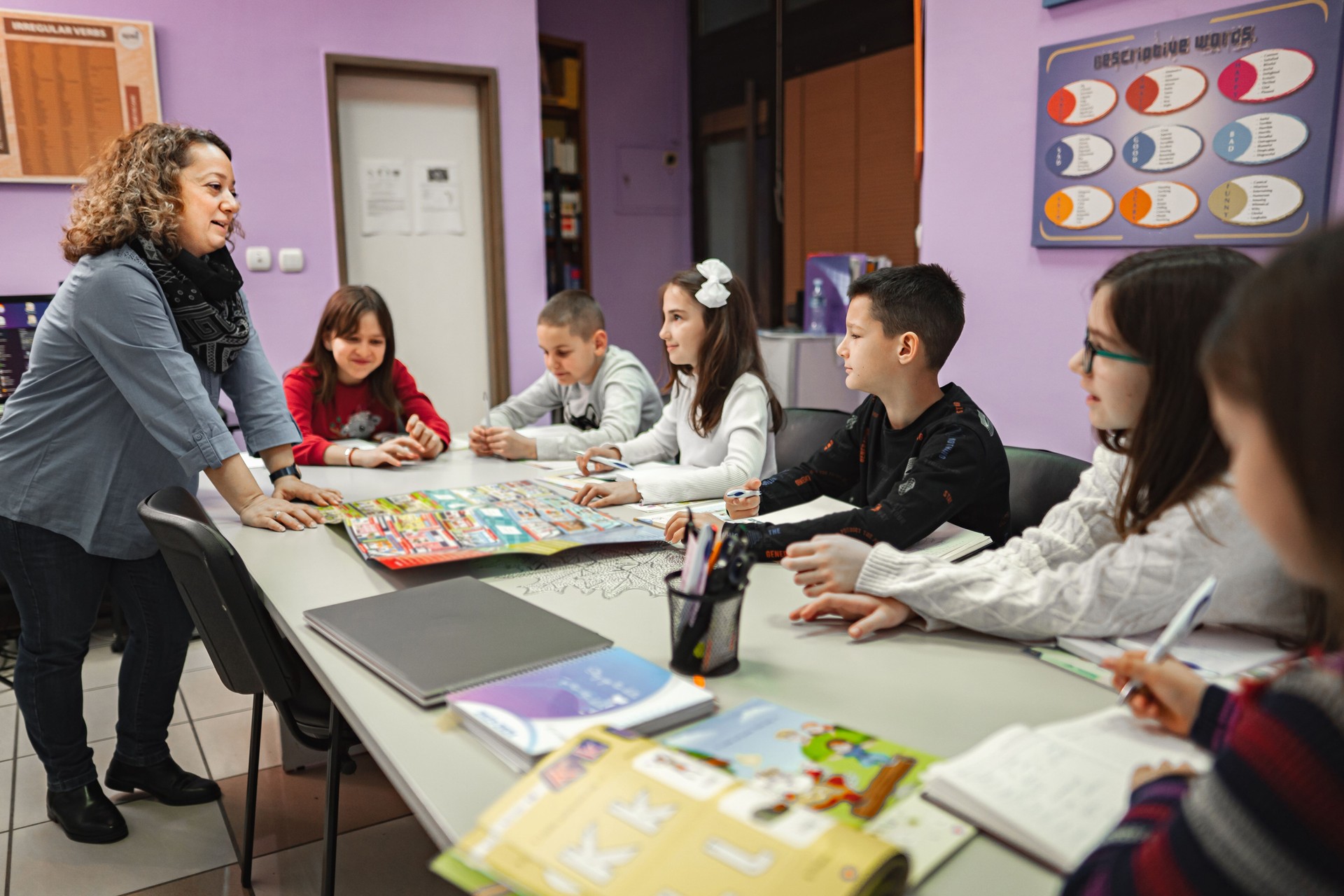 Woman teaching a group of elementary students at language school